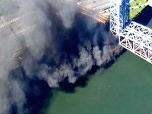 A fire eerupts under the 138th Street lift bridge, which carries all Metro-North trains.