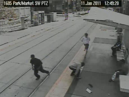 The victim (top of photo) runs away while the muggers snatch up and run with the loot.